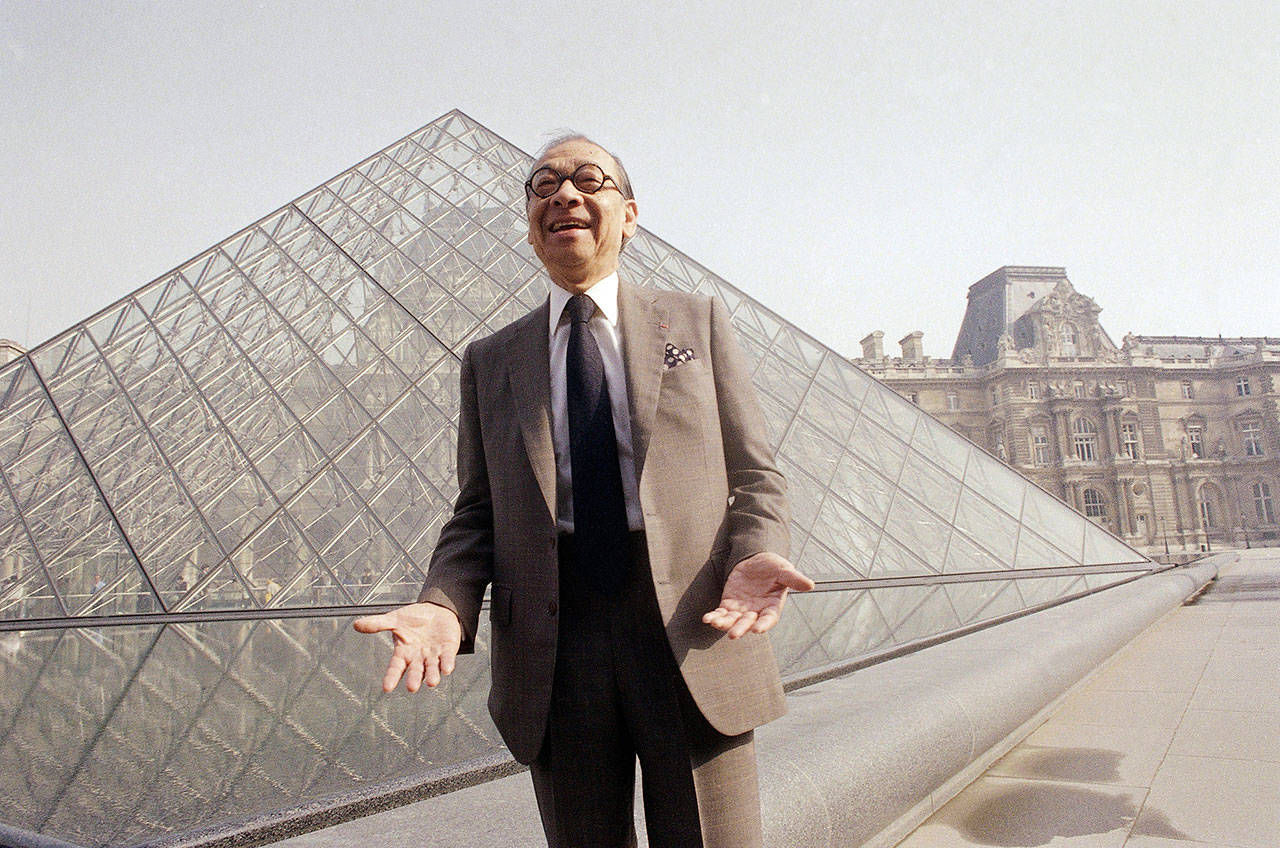 Chinese-American architect I.M. Pei laughs while posing for a portrait in front of the Louvre glass pyramid, which he designed, in the museum’s Napoleon Courtyard, prior to its inauguration in Paris on March 29, 1989. Pei, the globe-trotting architect who revived the Louvre museum in Paris with a giant glass pyramid and captured the spirit of rebellion at the multi-shaped Rock and Roll Hall of Fame, has died at age 102, a spokesman confirmed Thursday, May 16, 2019. (AP Photo/Pierre Gleizes, File)