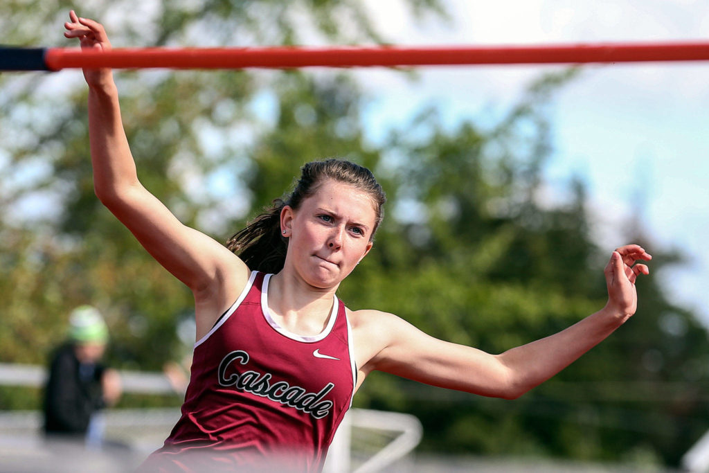 Cascade junior Katie Nelson runs and winds up for the high jump. She cleared a personal-best 5 feet, 5 inches to claim a district crown. (Kevin Clark / The Herald)
