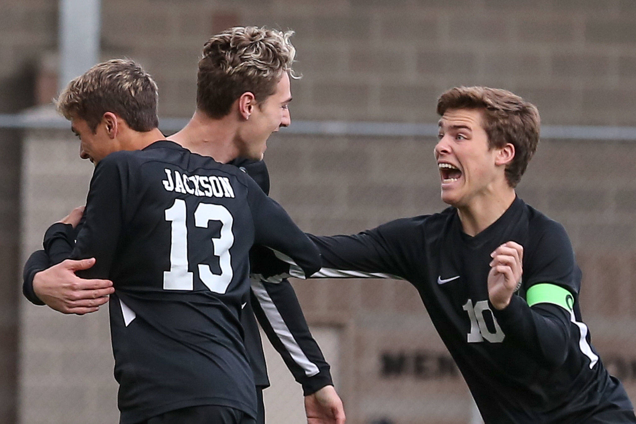 Jackson’s Adan Fernandez (left) and Jacob Williams (right) congratulate Vincenzo D’Onofrio (center) on his goal against Federal Way during a 4A state soccer match on May 17, 2019, at Everett Memorial Stadium. The Timberwolves won 2-1. (Kevin Clark / The Herald)