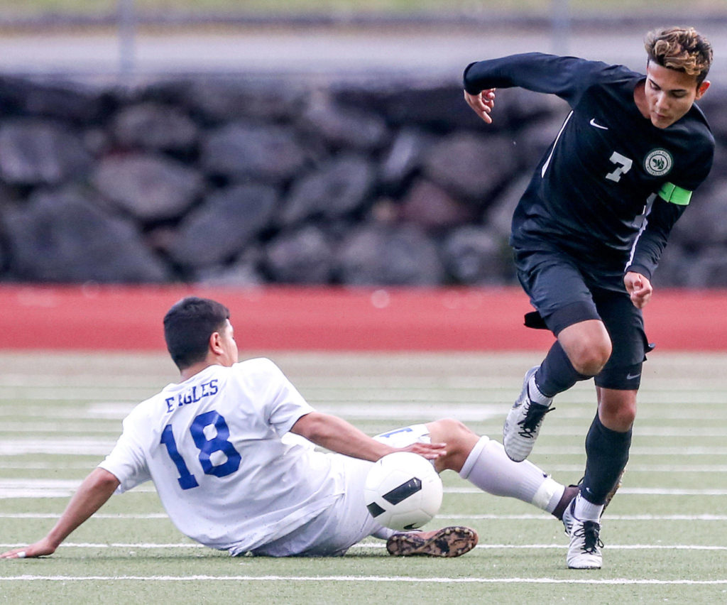 Jackson’s Kevin Giessler (right) avoids a tackle attempt by Federal Way’s David Sanchez-Benetiz during a 4A state soccer match on May 17, 2019, at Everett Memorial Stadium. The Timberwolves won 2-1. (Kevin Clark / The Herald)
