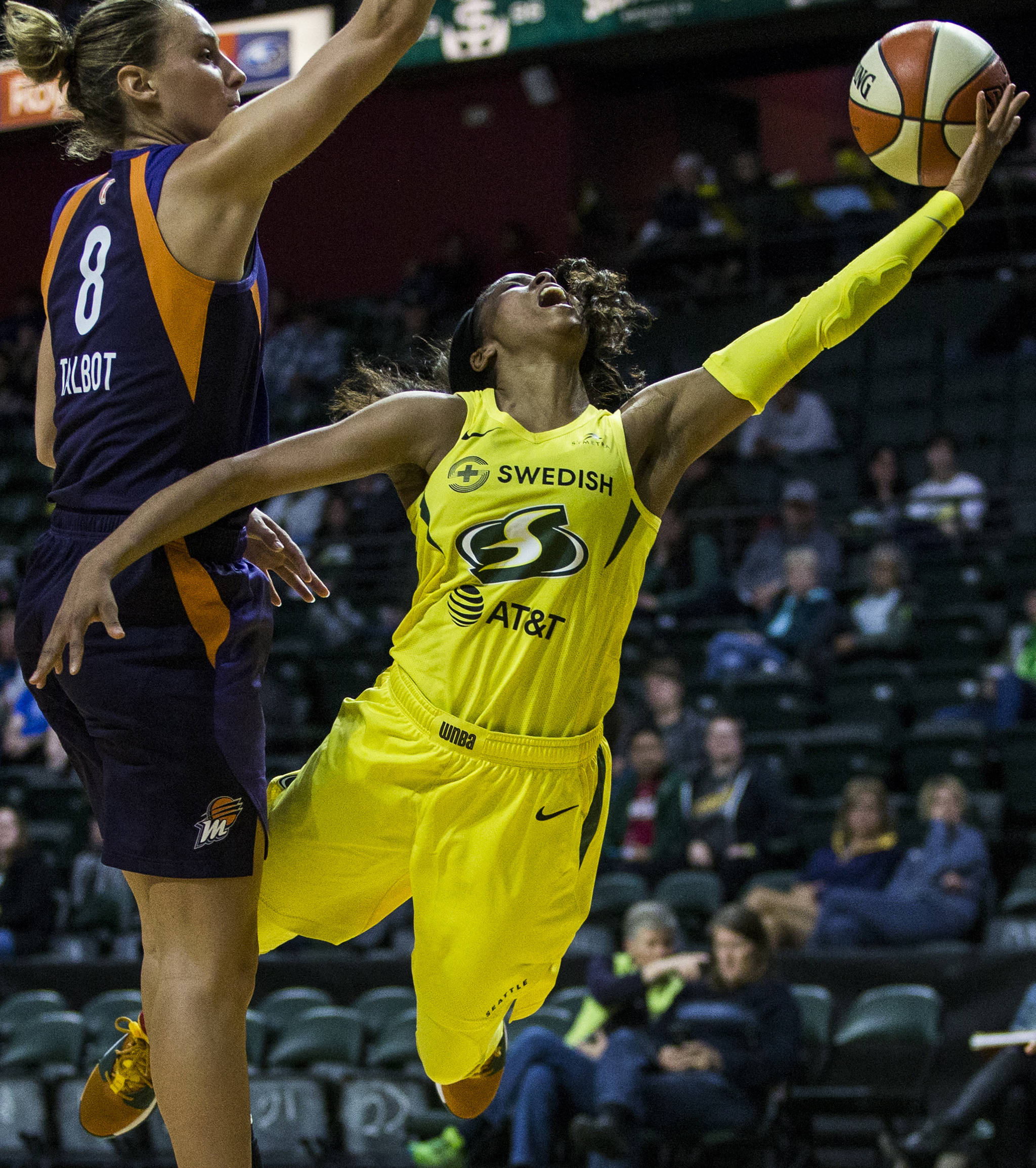 Seattle Storm’s Jordin Canada (right) gets fouled by Phoenix Mercury’s Stephanie Talbot during the preseason game against the Phoenix Mercury at Angel of the Winds Arena on May 15 in Everett. (Olivia Vanni / The Herald)