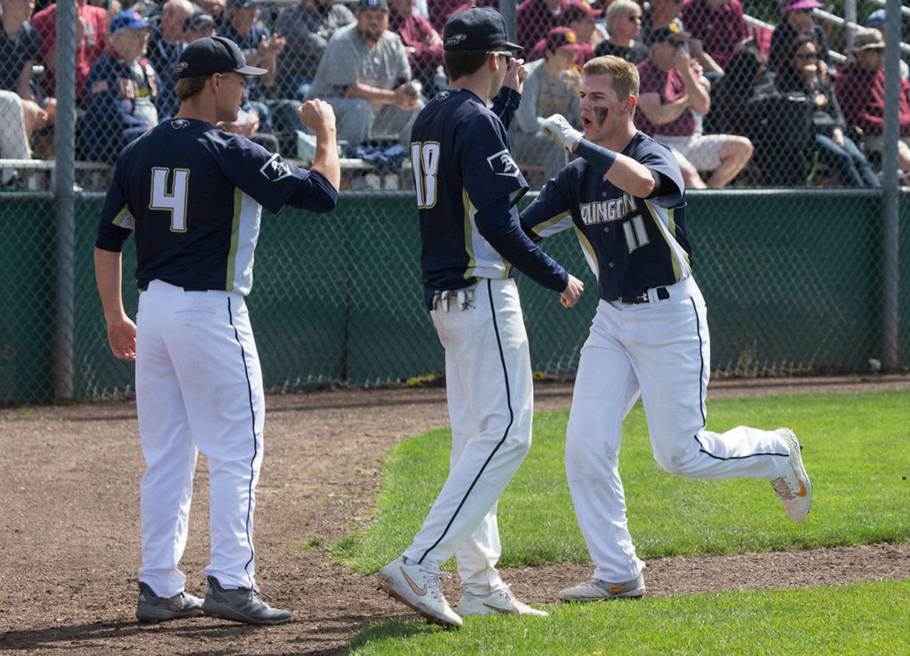 Arlington’s Cole Warner (11) celebrates after scoring a run. (Andy Bronson / The Herald)
