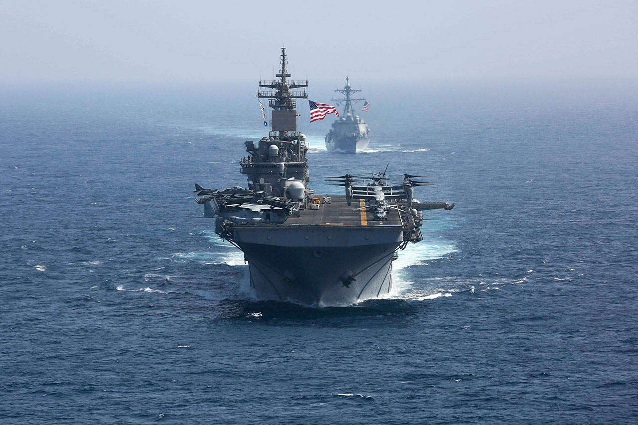 The amphibious assault ship USS Kearsarge and the Arleigh Burke-class guided-missile destroyer USS Bainbridge sail in formation Friday as part of the USS Abraham Lincoln aircraft carrier strike group in the Arabian Sea. Commercial airliners flying over the Persian Gulf risk being targeted by miscalculation or misidentification from the Iranian military amid heightened tensions between the Islamic Republic and the U.S., American diplomats warned Saturday, May 18, 2019, even as both Washington and Tehran say they dont seek war. (Mass Communication Specialist 1st Class Brian M. Wilbur, U.S. Navy via AP)