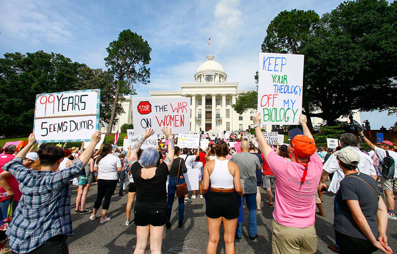 Protesters for women’s rights hold a rally Sunday on the Alabama Capitol steps in Montgomery to protest a law passed last week making abortion a felony in nearly all cases with no exceptions for cases of rape or incest. (AP Photo/Butch Dill)