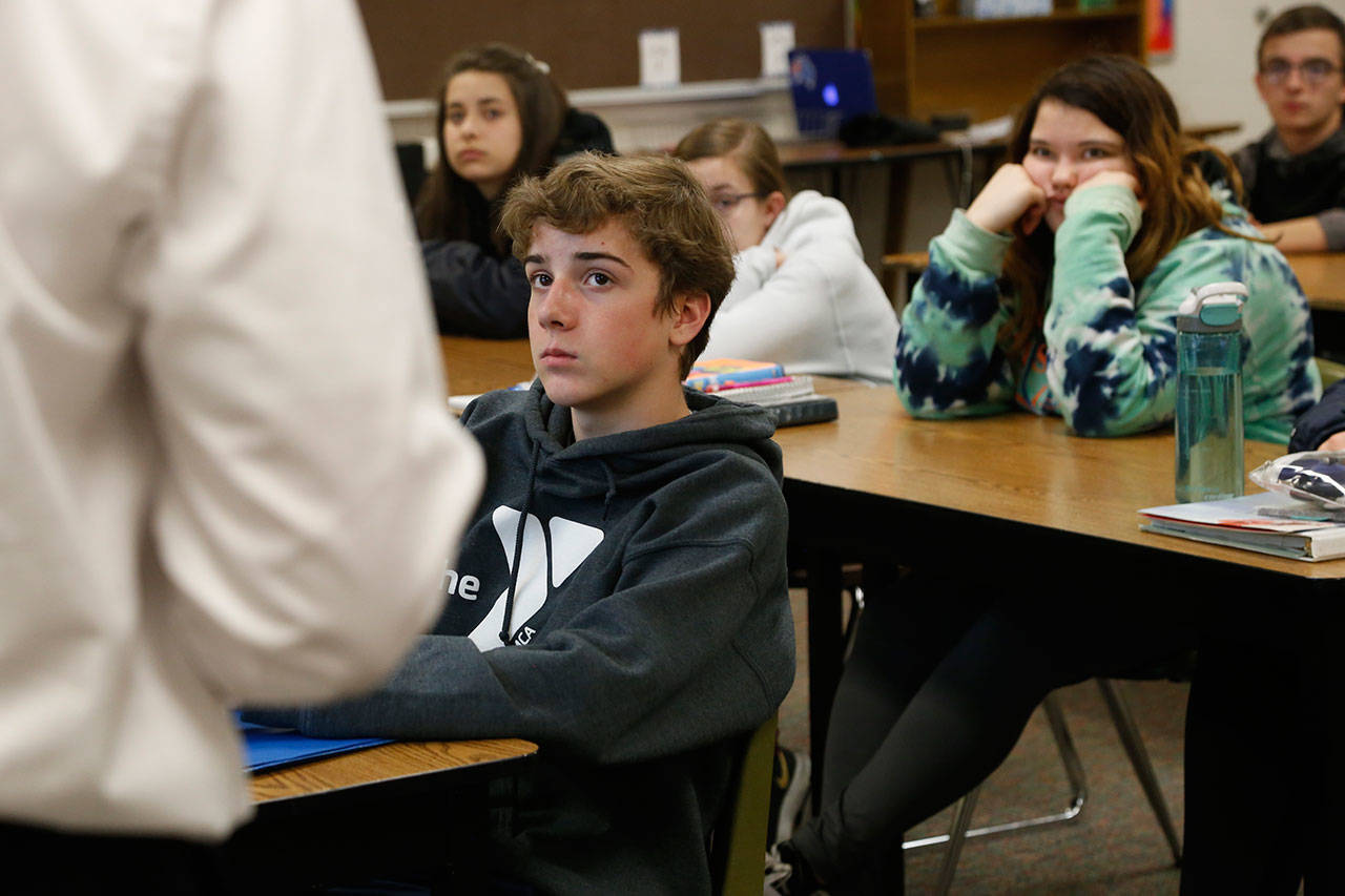 High school freshmen listen to Wexford County prosecutor Jason Elmore talk about consent and criminal sexual conduct April 17 in Cadillac, Michigan. Among other things, he reminded them that the legal age of consent for sexual contact in the state of Michigan is 16. Most of the students in these classes are younger than that. (AP Photo/Martha Irvine)