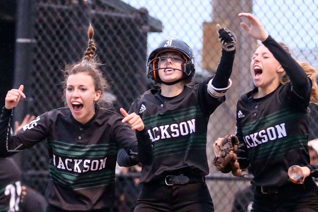 The Jackson High School softball team celebrates a home run in the fourth inning of their 5-3 victory over Lake Stevens in the semifinals of the district tournament on May 15 at Phil Johnson Fields in Everett. (Kevin Clark / The Herald)