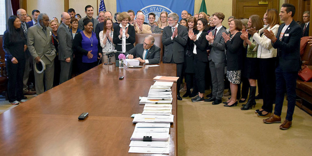 Gov. Jay Inslee signs the 2019–21 operating budget on May 21. (Office of the Governor photo)
