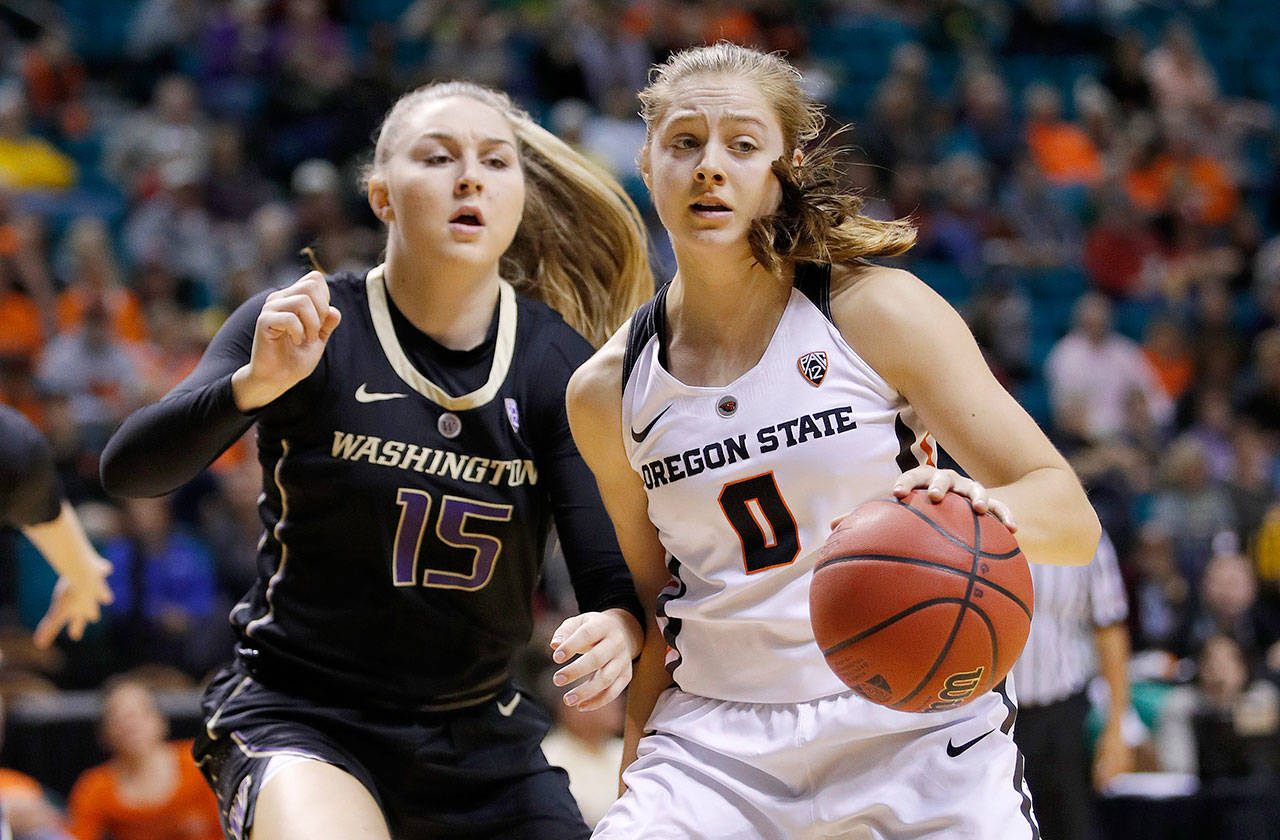Oregon State’s Mikayla Pivec drives next to Washington’s Haley Van Dyke during the second half of an NCAA college basketball game at the Pac-12 women’s tournament on March 8 in Las Vegas. (AP Photo/John Locher)