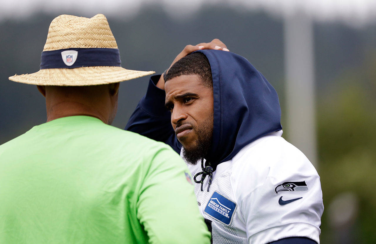 Seahawks linebacker Bobby Wagner (right) talks with defensive coordinator Ken Norton Jr. during a practice on May 21, 2019, in Renton. (AP Photo/Elaine Thompson)