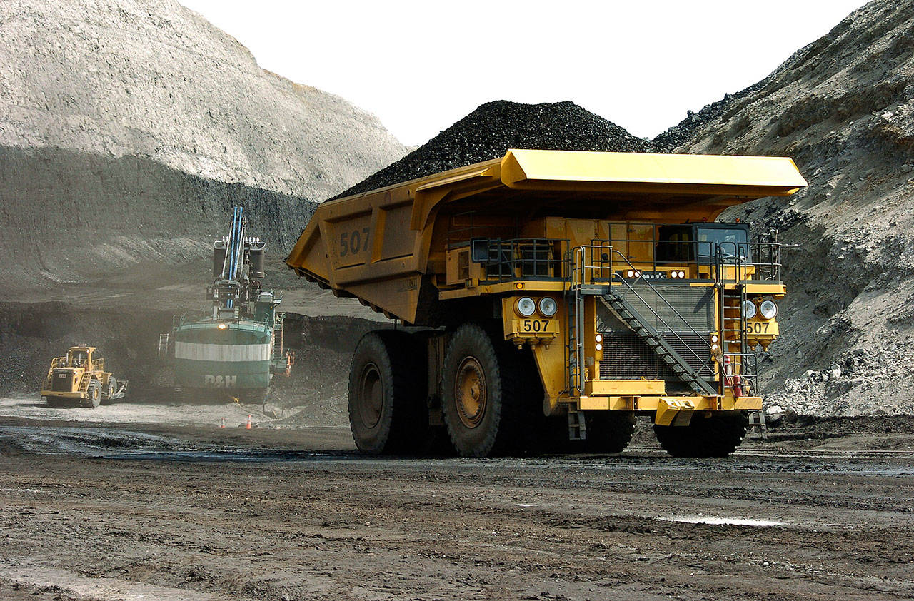 A truck carrying 250 tons of coal hauls the fuel to the surface of the Spring Creek mine near Decker, Montana, in 2013. Federal officials say the Trump administration’s decision to lift a moratorium on coal sales from public lands could hasten the release of more than 5 billion tons of greenhouse gasses. The report comes after a court ruled last month that the administration failed to consider the environmental effects of its resumption in 2017 of coal sales. A moratorium had been imposed under President Barack Obama over worries about climate change. (AP Photo/Matthew Brown, File)