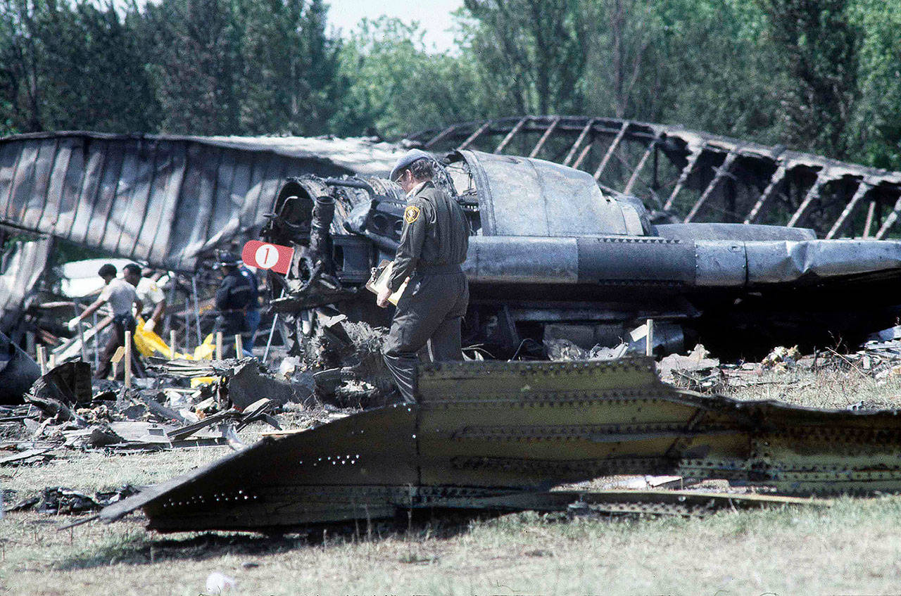 Investigators view the wreckage of the ill-fated American Airlines Flight 191 to Los Angeles a day after it crashed on takeoff in Chicago on May 25, 1979. (AP Photo/Fred Jewell, file)