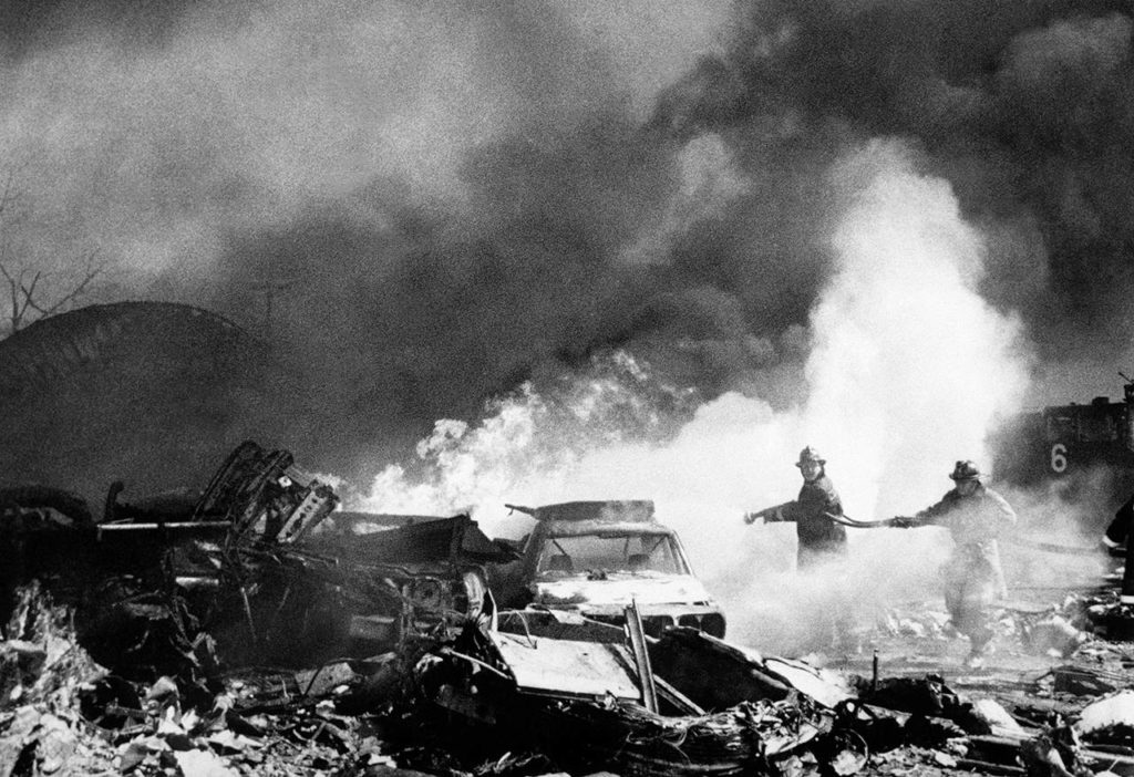 Firemen pour water on flaming wreckage of American Airlines Flight 191 DC-10 aircraft shortly after it crashed on takeoff from Chicago’s O’Hare Airport on May 25, 1979. At left is an engine nacelle that smashed into several cars parked in a trailer court where the jet crashed. (AP Photo, file)

