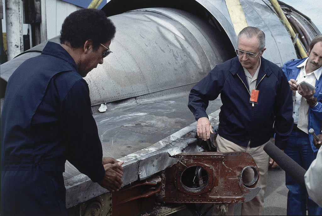 William Schaefer of American Airlinesc (right) and Elwood Driver of the National Transportation Safety Board (left) examine the engine that fell off the DC-10 in Chicago on May 26, 1979, the day after the worst aviation disaster in the nation’s history. Reporters take notes behind Schaefer. (AP Photo/Fred Jewell, file)

