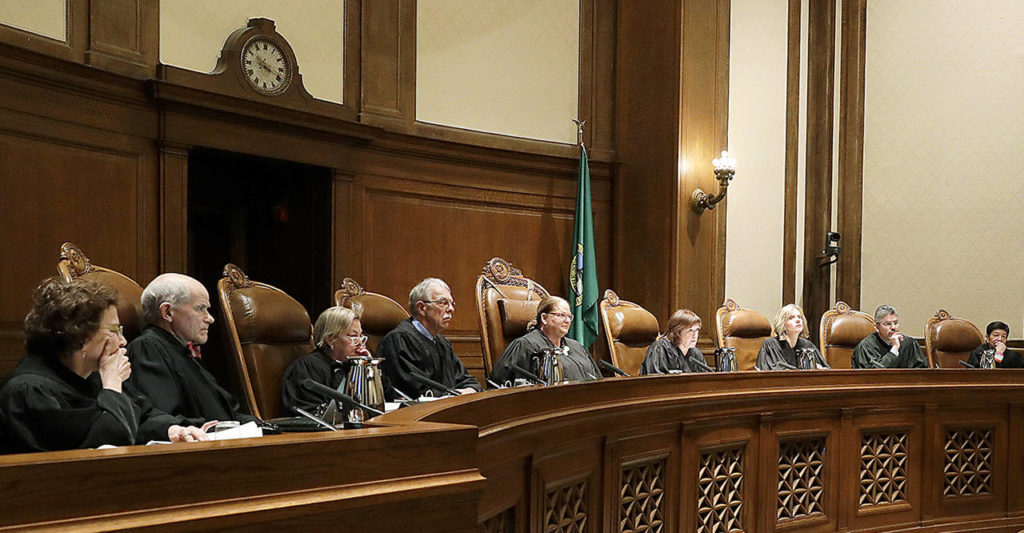 Justices on the Washington Supreme Court listen to testimony during a Jan. 22 hearing in Olympia, on a lawsuit addressing the constitutional freedom of state presidential electors to vote for any candidate for president, not just the nominee of their party. (AP Photo/Ted S. Warren, file)
