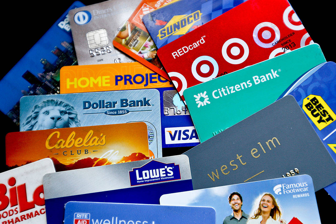 An assortment of credit cards and rewards cards are shown in Zelienople, Pa. Rewards-earning credit cards can help you save on these expenses — but you can also combine those rewards with other money-saving strategies to help you hang on to even more of your cash. (Associated Press/ Keith Srakocic)