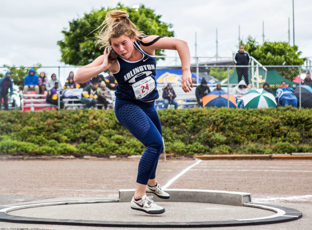 Arlington’s Julia Parra winds up to throw the shot during the second day of competition at the 4A/3A/2A State Track Field Championships on Friday at Mount Tahoma High School. Parra placed second in the 3A girls shot put. (Olivia Vanni / The Herald)
