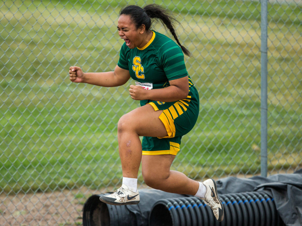 Shorecrest’s Kiana Lino jumps in the air after achieving a personal best in the shot put Friday during the second day of competition at the 4A/3A/2A State Track Field Championships at Mount Tahoma High School in Tacoma. (Olivia Vanni / The Herald)
