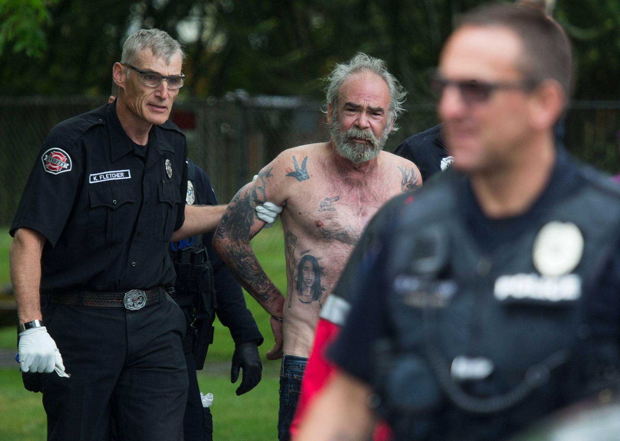 Medics take Jeff Phebus, the suspect in a fatal shooting, to an ambulance Friday on McDougall Avenue in Everett. (Andy Bronson / The Herald)