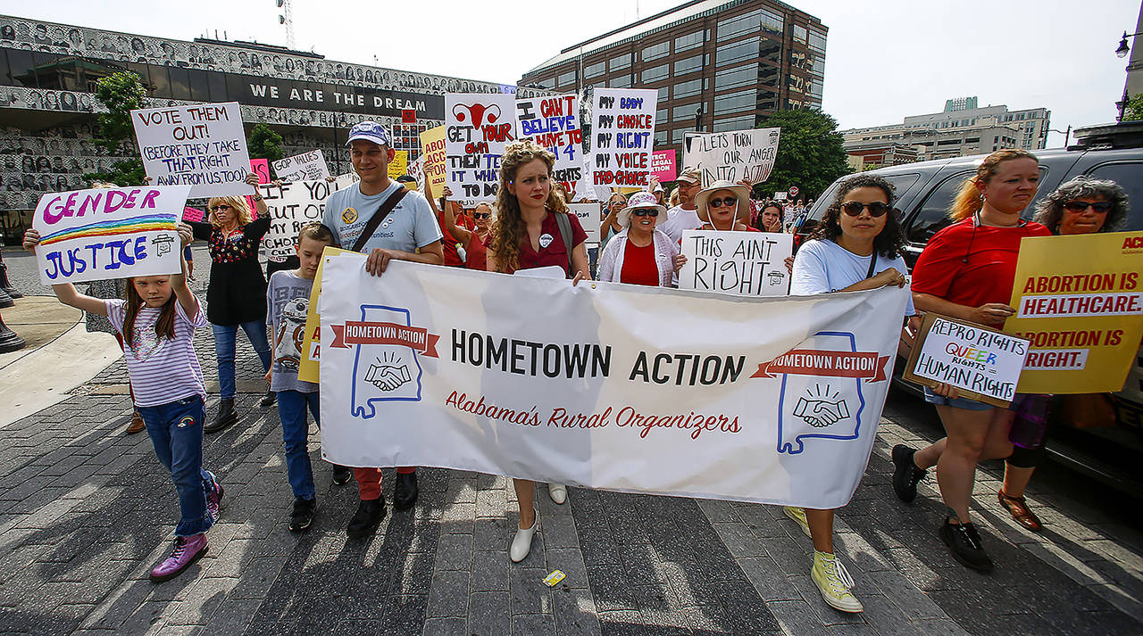 In this May 19 photo, protesters for women’s rights march to the Alabama Capitol to protest a law passed last week making abortion a felony in nearly all cases, with no exceptions for cases of rape or incest, in Montgomery, Alabama. (AP Photo/Butch Dill)