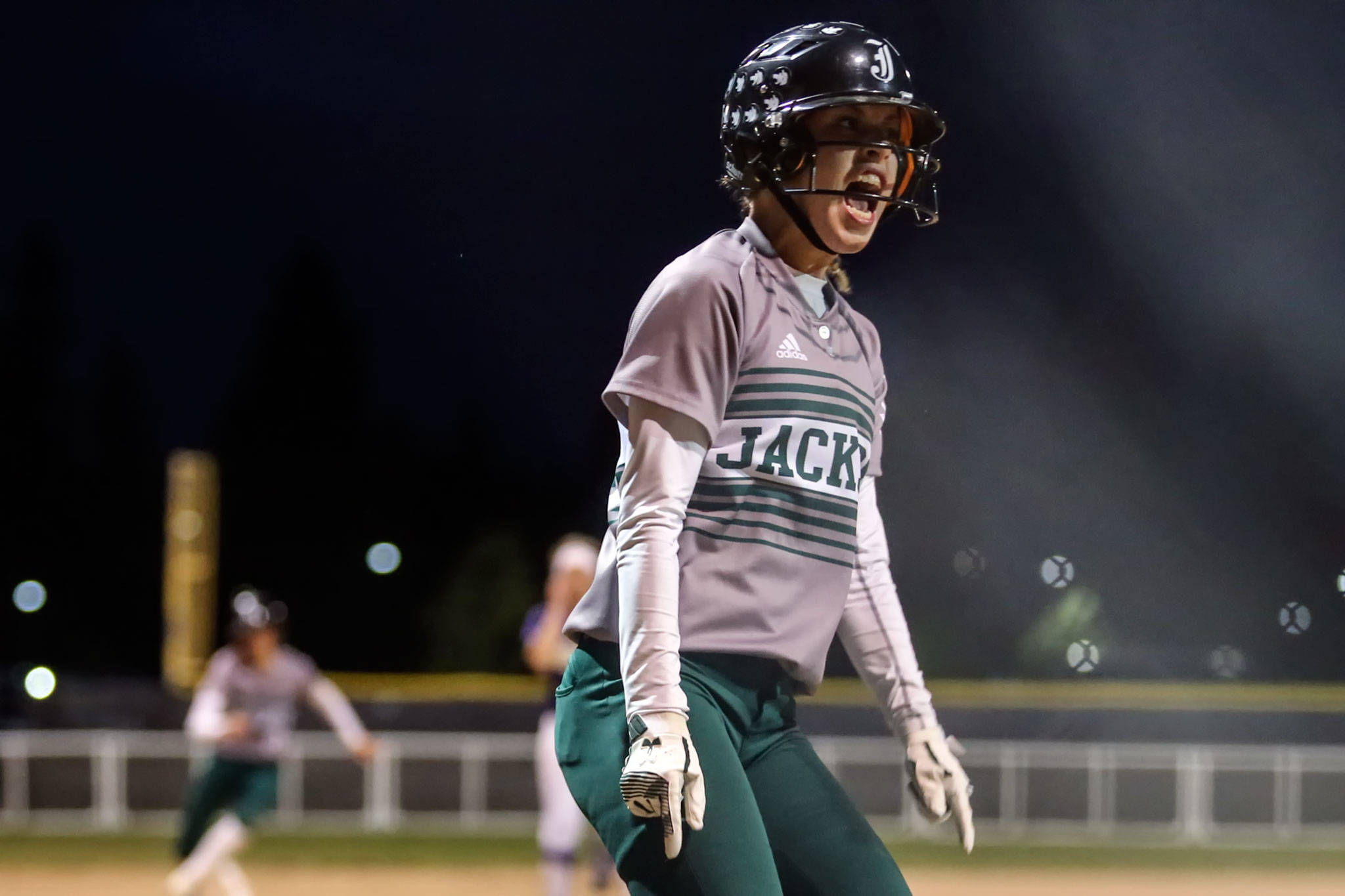 Jackson’s Julia Dillion celebrates after scoring a run during the Timberwolves’ 16-2 rout of Wesco 4A rival Lake Stevens in Saturday night’s 4A state championship game at Dwight Merkel Sports Complex in Spokane. (Kevin Clark / The Herald)