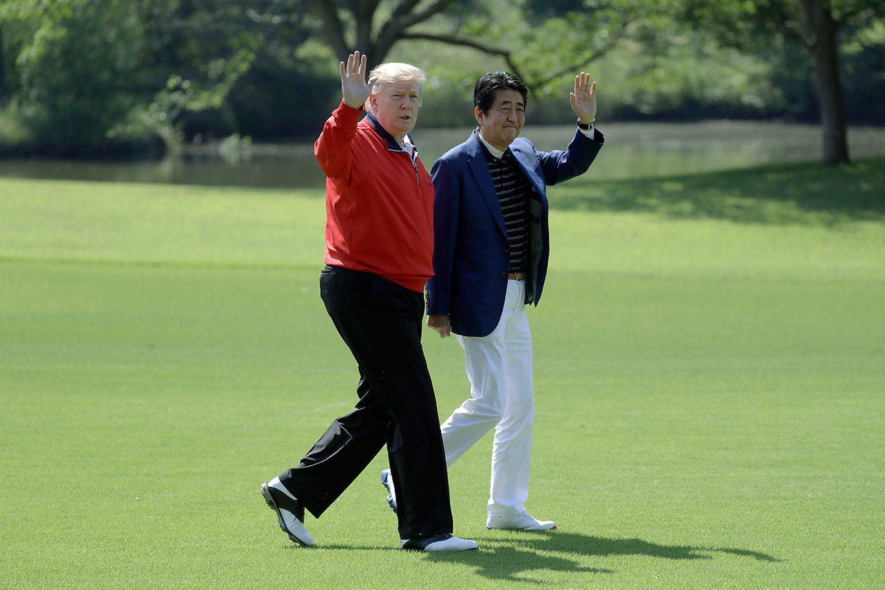President Donald Trump walks with Japanese Prime Minister Shinzo Abe before playing a round of golf Sunday at Mobara Country Club in Chiba, Japan. (AP Photo/Evan Vucci)