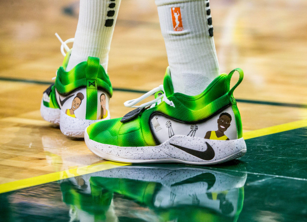 Seattle Storm’s Natasha Howard wears custom shoes with small illustrations of herself, her teammates and championship trophies during the season opener game against the Phoenix Mercury on Saturday, May 25, 2019 in Everett, Wash. (Olivia Vanni / The Herald)
