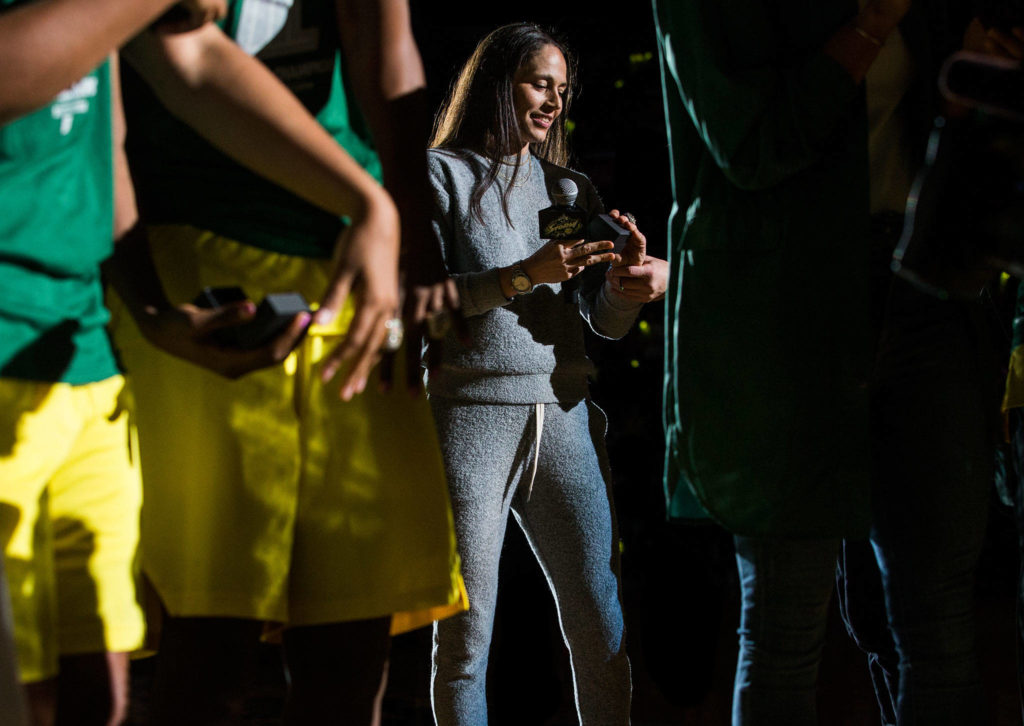 Seattle Storm’s Sue Bird admires her championship ring after the ring ceremony before the season opener game against the Phoenix Mercury on Saturday, May 25, 2019 in Everett, Wash. (Olivia Vanni / The Herald)
