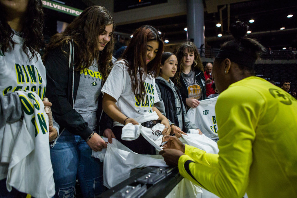 Seattle Storm’s Jewell Loyd signs fan’s t-shirts before the start of the season opener game against the Phoenix Mercury on Saturday, May 25, 2019 in Everett, Wash. (Olivia Vanni / The Herald)
