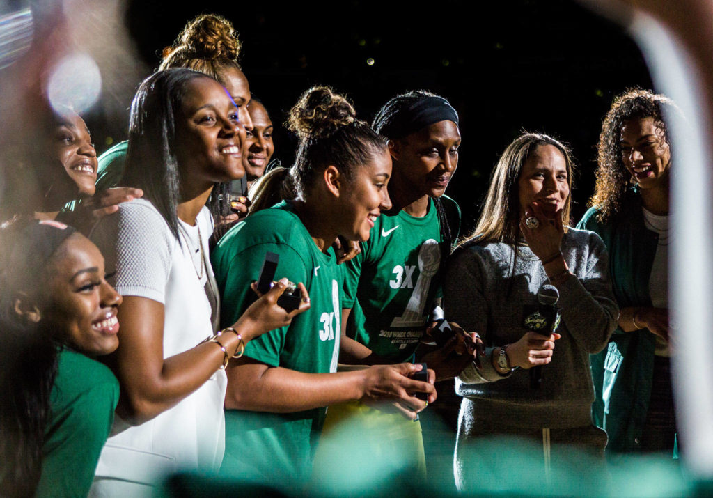 The Seattle Storm show off their championship rings for the television cameras after the ring ceremony before the season opener game against the Phoenix Mercury on Saturday, May 25, 2019 in Everett, Wash. (Olivia Vanni / The Herald)
