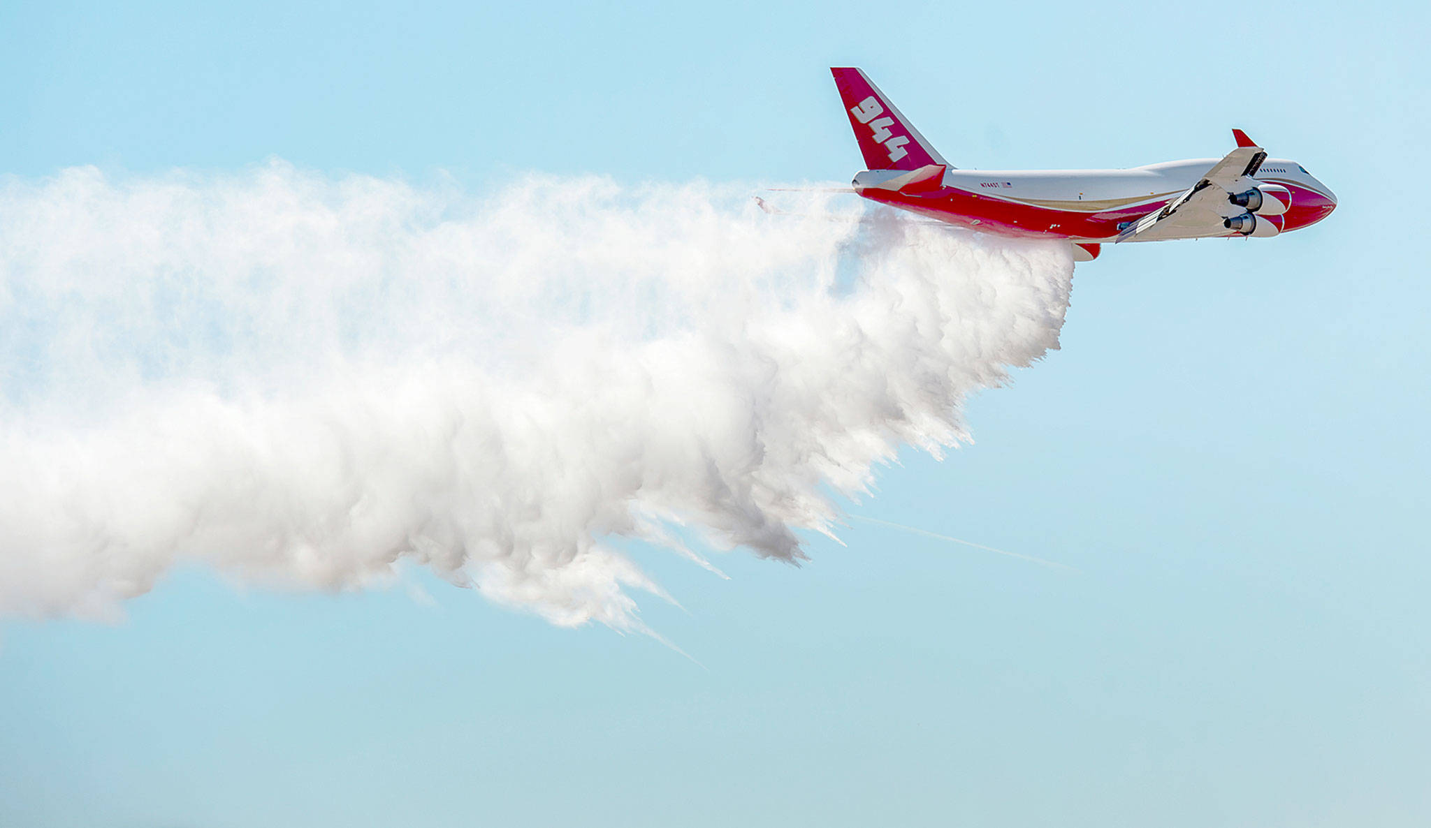 The Boeing 747-400 Global SuperTanker drops half a load of its 19,200-gallon capacity during a ceremony at Colorado Springs, Colorado, in 2016. (Christian Murdock/The Gazette via AP, File)