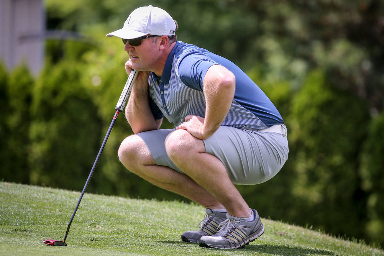 Jacob Rohde check his sight line Sunday afternoon during the second round of the Snohomish County Amateur Golf Tournament at Harbour Pointe Golf Club in Mukilteo on May 26, 2019. Rohde took the first place with 4-under-par 70. (Kevin Clark / The Herald)