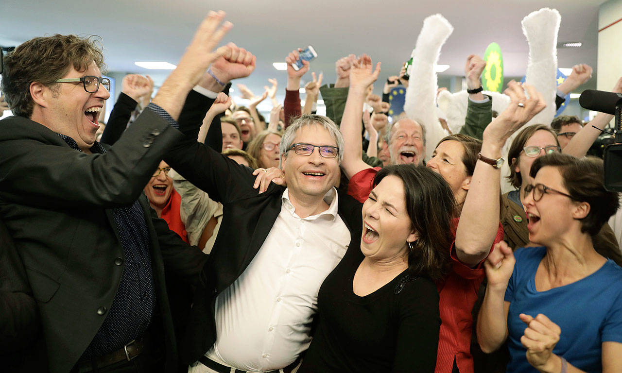Green party chairwoman Annalena Baerbock and EU parliament member Sven Giegold celebrate Sunday in Berlin after the first results from voting are announced. (Kay Nietfeld/dpa via AP)