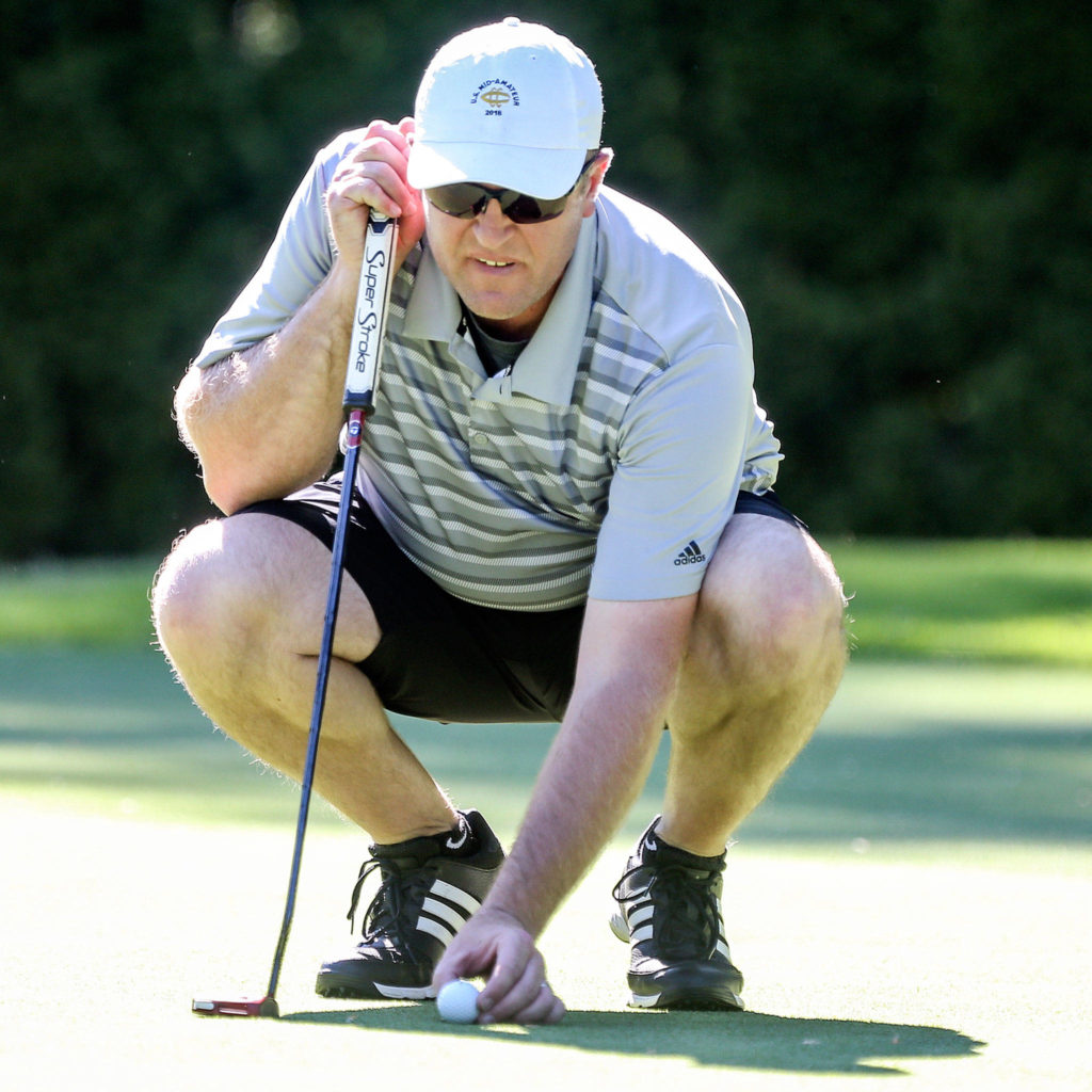 Jacob Rohde lines up a putt during the Snohomish County Amateur golf tournament Sunday at Everett Golf Country Club. Rohde, the defending champion, finished second after a sudden-death playoff.. (Kevin Clark / The Herald)

