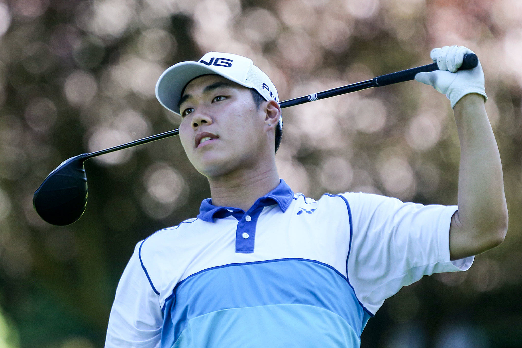 Alvin Kwak watches a tee shot during the final round of the Snohomish County Amateur golf tournament Monday in Everett. (Kevin Clark / The Herald)