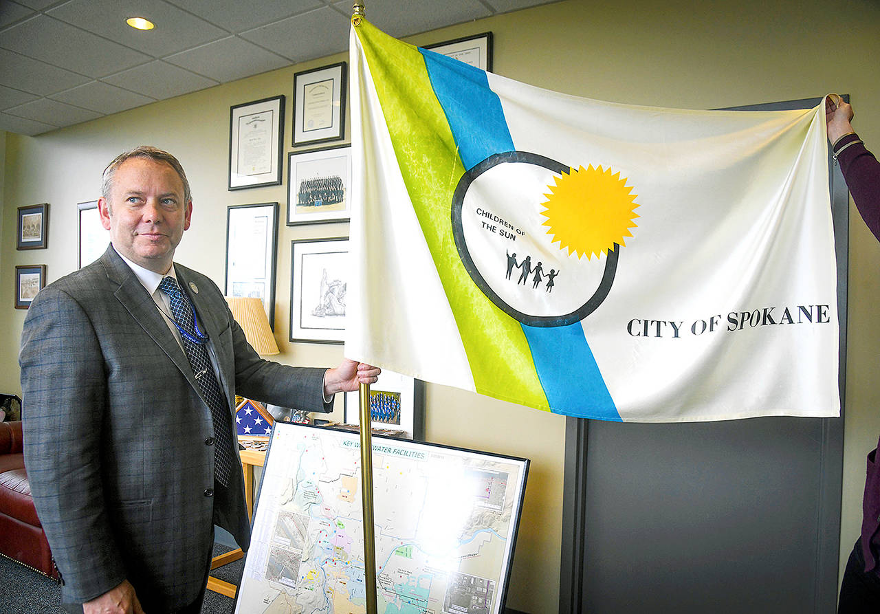 Spokane Mayor David Condon displays the City of Spokane flag in his office. (Dan Pelle/The Spokesman-Review via AP)