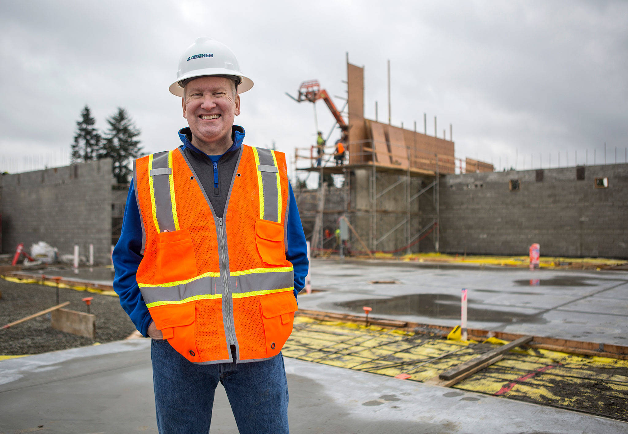 Ted Wenta, then senior vice president of operations for the YMCA of Snohomish County, stands on the concrete slab of what would become the main gym of the new Everett YMCA last November. (Olivia Vanni / The Herald)