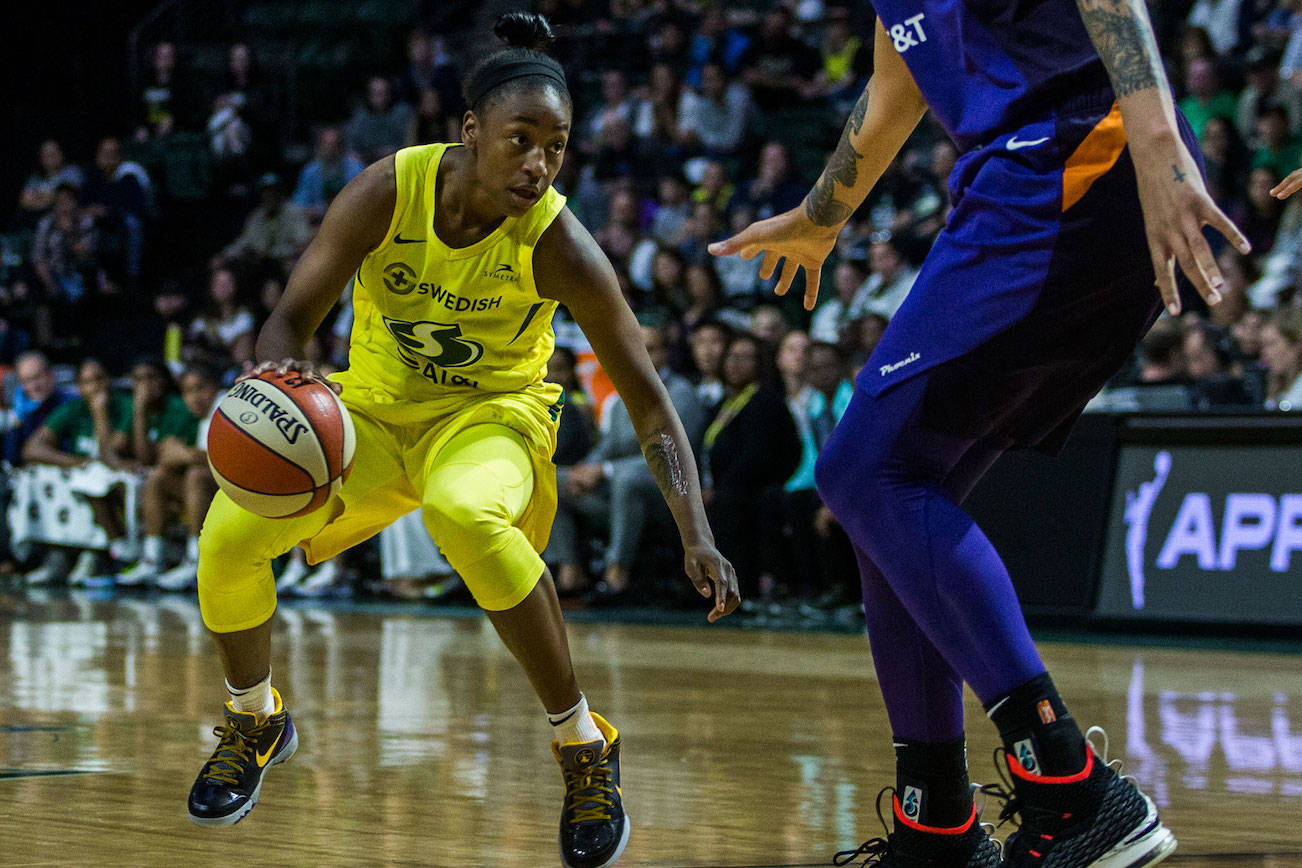 The Seattle Storm’s Jewell Loyd dribbles around the Phoenix Mercury’s Brittney Griner during the season opener on Saturday, May 25, 2019 in Everett, Wash. (Olivia Vanni / The Herald)