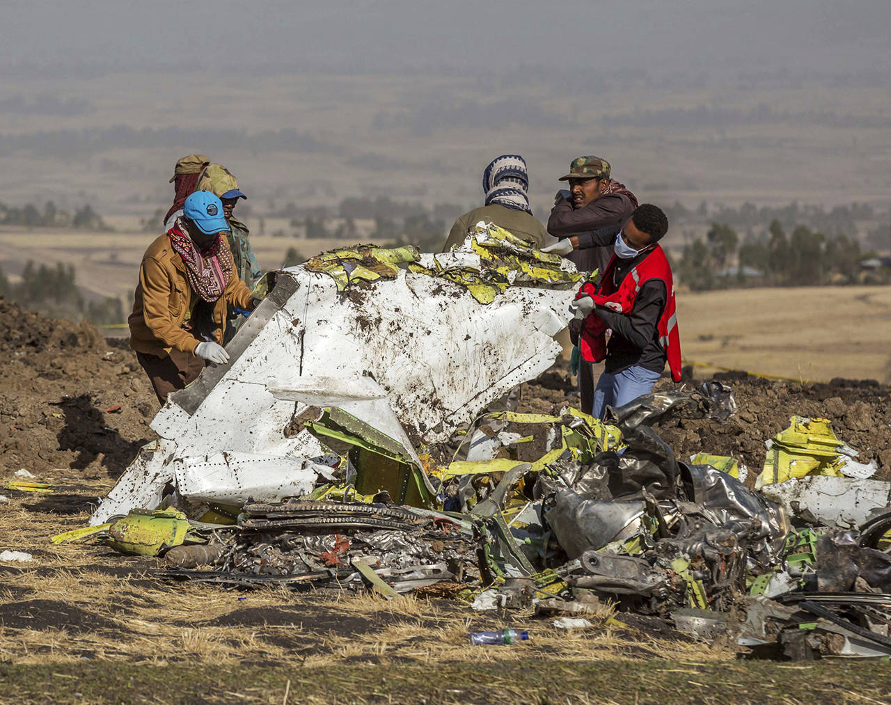 In this March 11 photo, rescuers work at the scene of an Ethiopian Airlines flight crash near Bishoftu, Ethiopia. Pilot Bernd Kai von Hoesslin pleaded with his bosses for more training on the Boeing Max, just weeks before the Ethiopian Airline’s jet crashed, killing everyone on board. (AP Photo/Mulugeta Ayene, File)