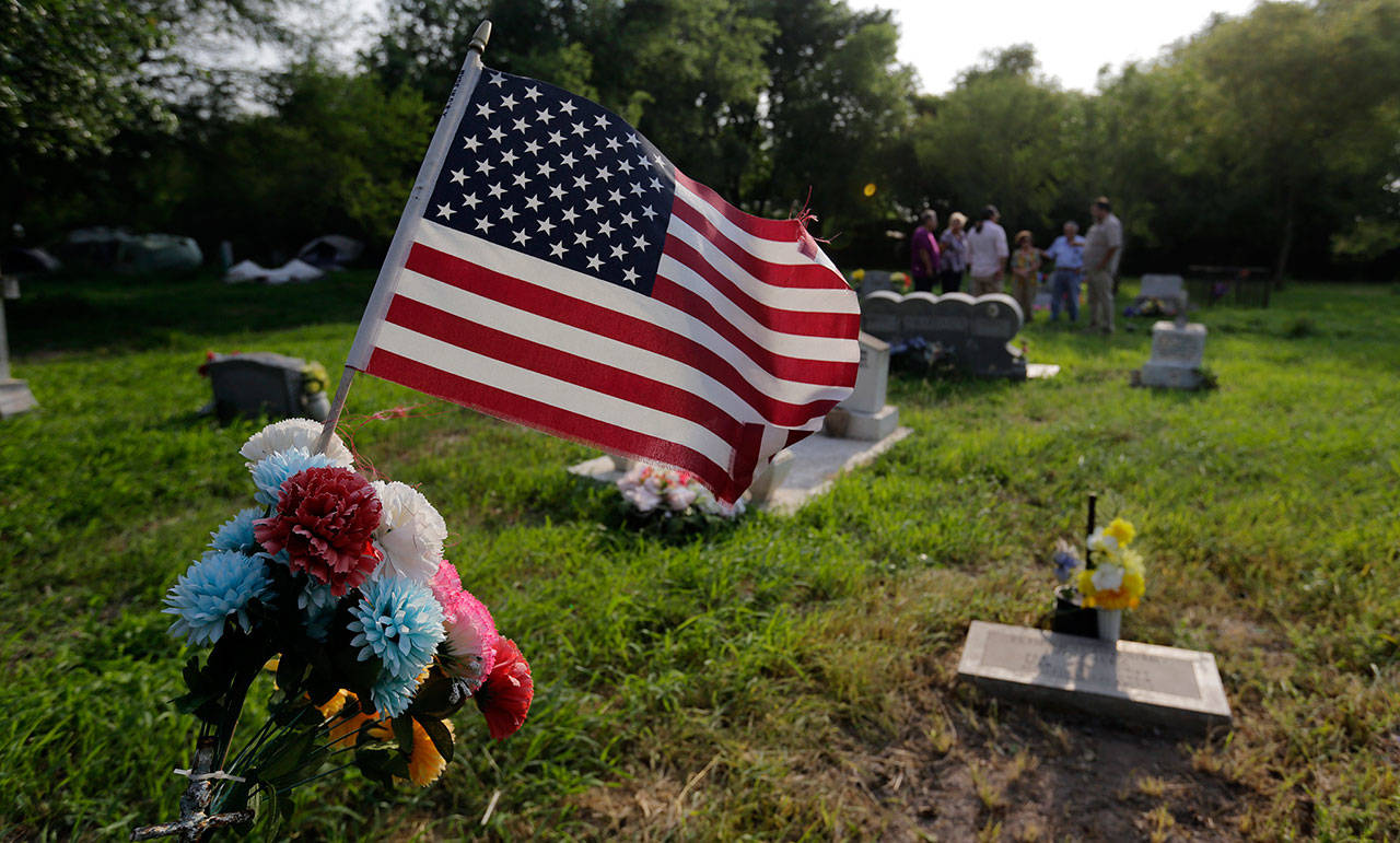 Family members gather at the Eli Jackson Cemetery in San Juan, Texas, on May 1. Under current plans for the border wall, one of the 19th century cemeteries could be lost entirely. Some graves would have to be exhumed; others without a headstone might be paved over. (AP Photo/Eric Gay)