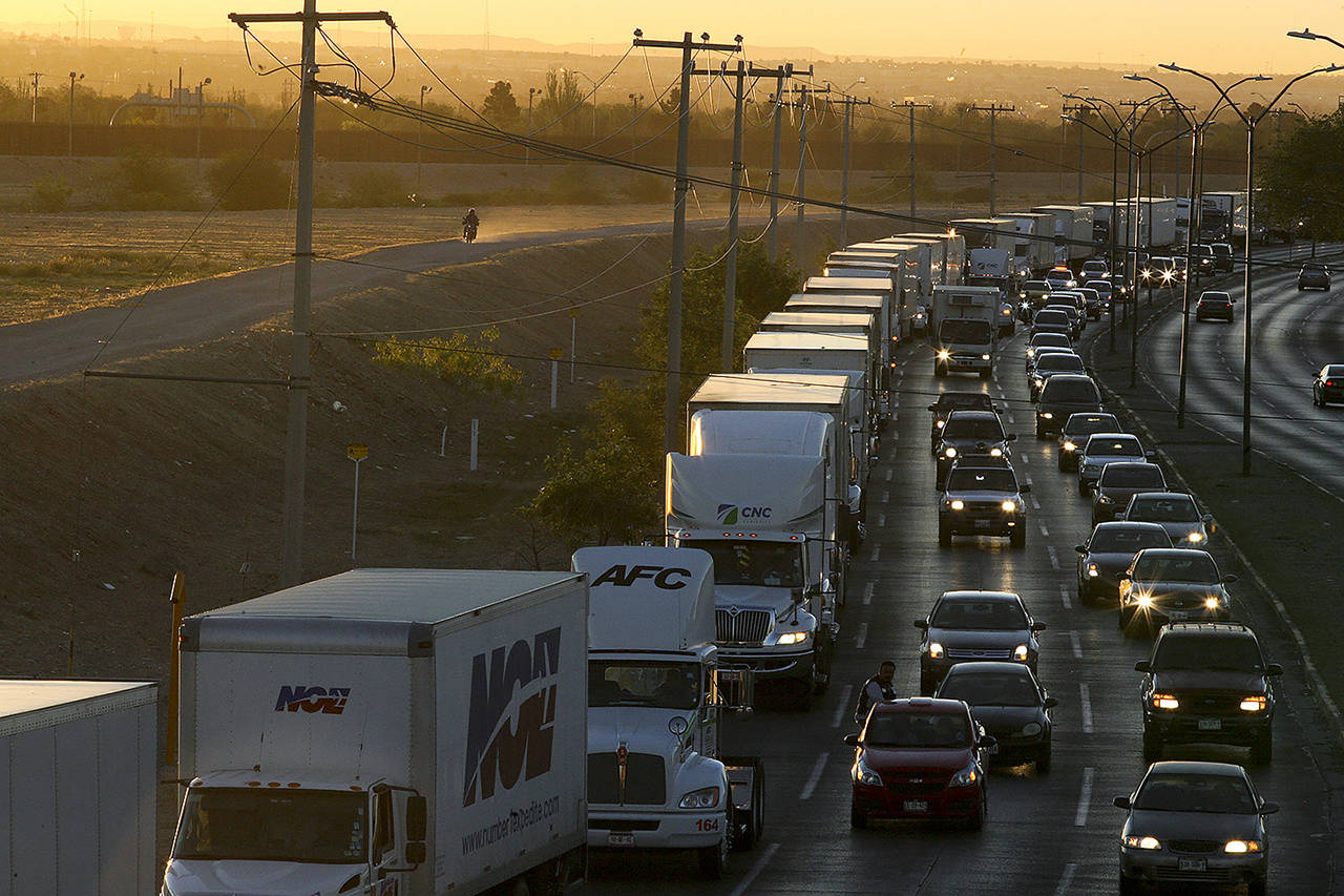 In this April 9 photo, trucks wait to cross the border with the U.S. in Ciudad Juarez, Mexico. In a surprise announcement that could compromise a major trade deal, President Donald Trump announced Thursday that he is slapping a 5% tariff on all Mexican imports to pressure the country to do more to crack down on the surge of Central American migrants trying to cross the U.S. border. (AP Photo/Christian Torres, File)