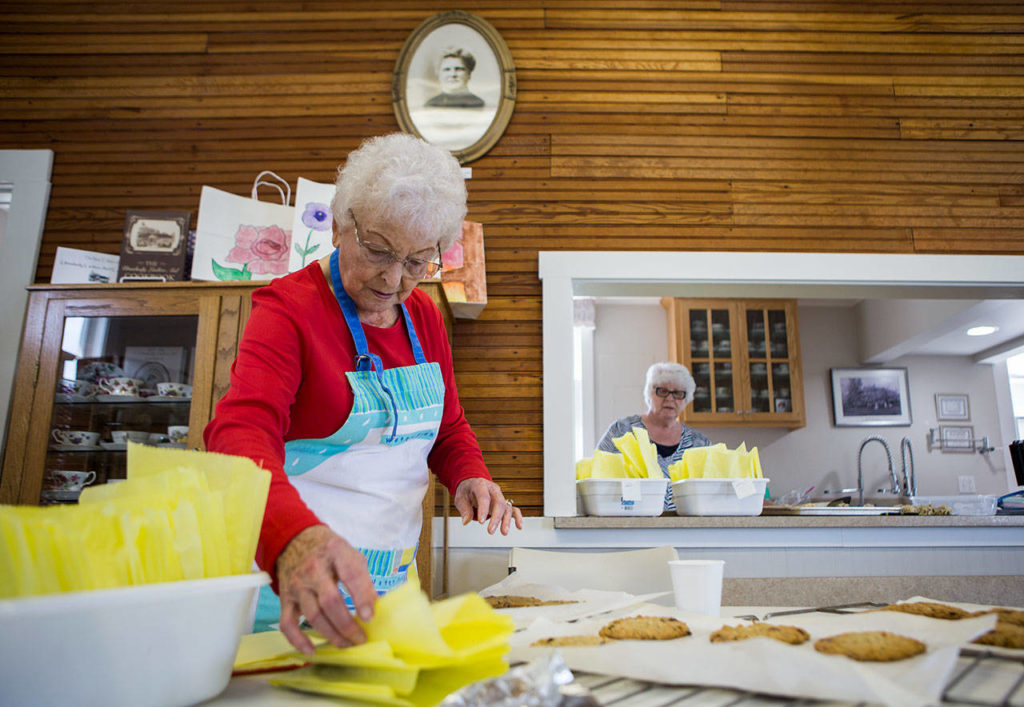 Carol Kruse (left) and Mary-Margaret Haugen count how many cookies they’ve made at the Utsalady Ladies Aid building. (Olivia Vanni / The Herald)

