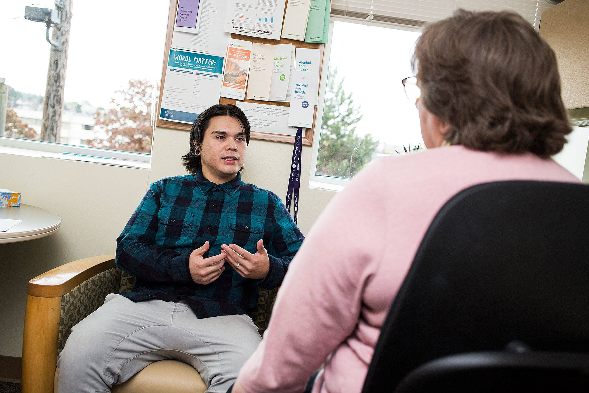 Kaiser Permanente nurse Eileen Krembs talks with patient John Haws, who is receiving in-office opiate addiction treatment in Everett. (Andy Bronson / The Herald)