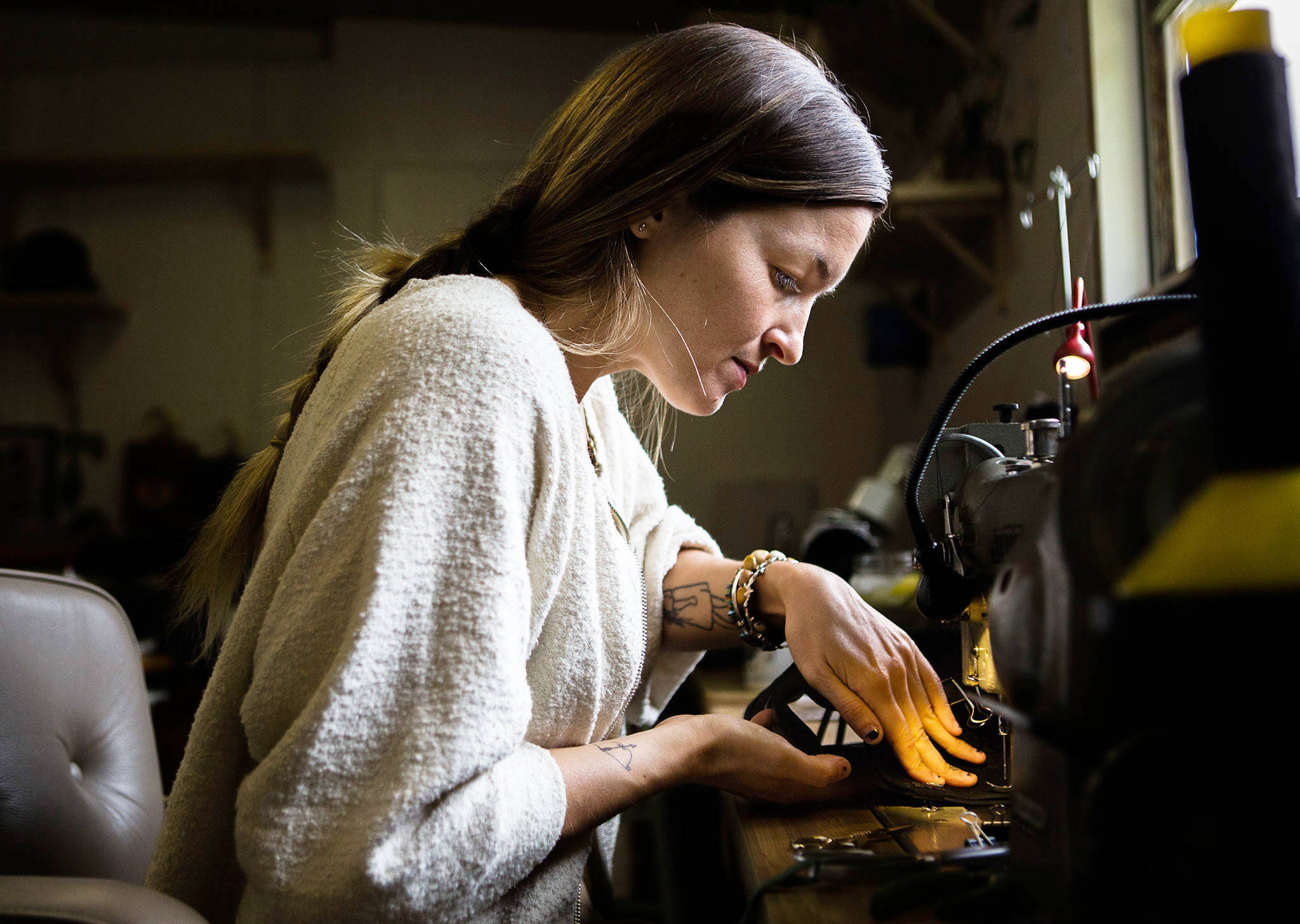 Madeline Chadwick works on a bucket bag in her work room at her home in Lake Stevens. (Olivia Vanni / The Herald)