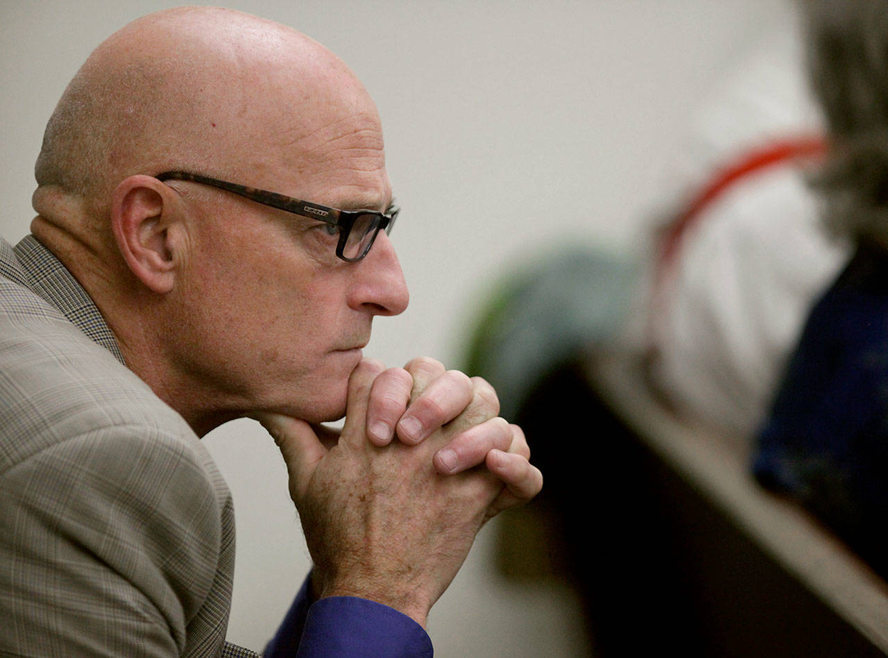Then-Snohomish County Prosecuting Attorney Mark Roe listens to opening statements in a case in Snohomish County Superior Court in Everett in 2012. (Mark Mulligan / Herald file)