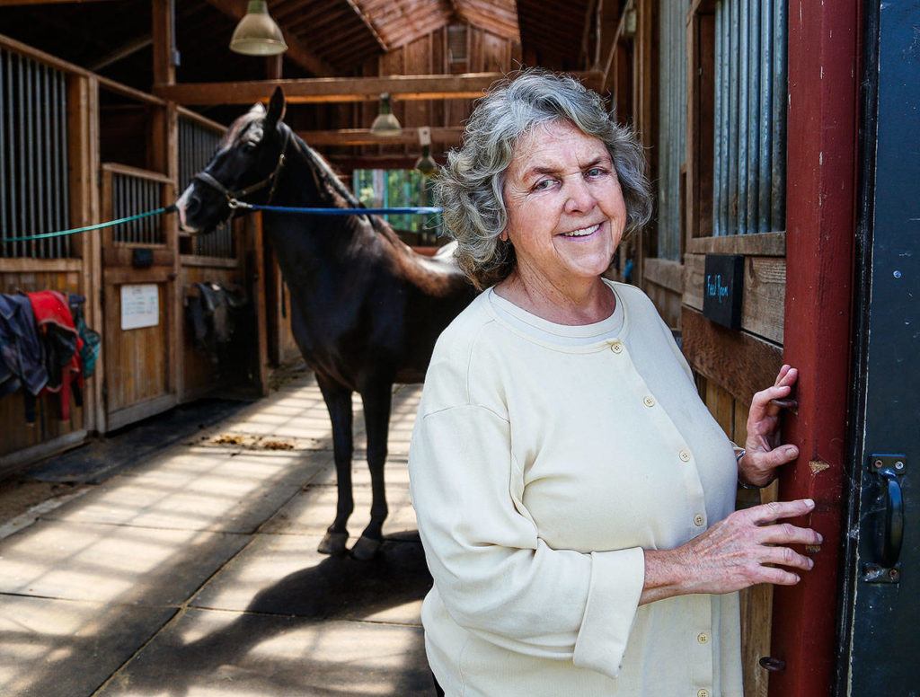 Dr. Suzanne Poppema of Edmonds, with her horse Lochinvar, at a Snohomish riding facility. An abortion provider for many years, before retiring the Edmonds woman is worried about laws limiting access to the procedure. (Dan Bates / The Herald)
