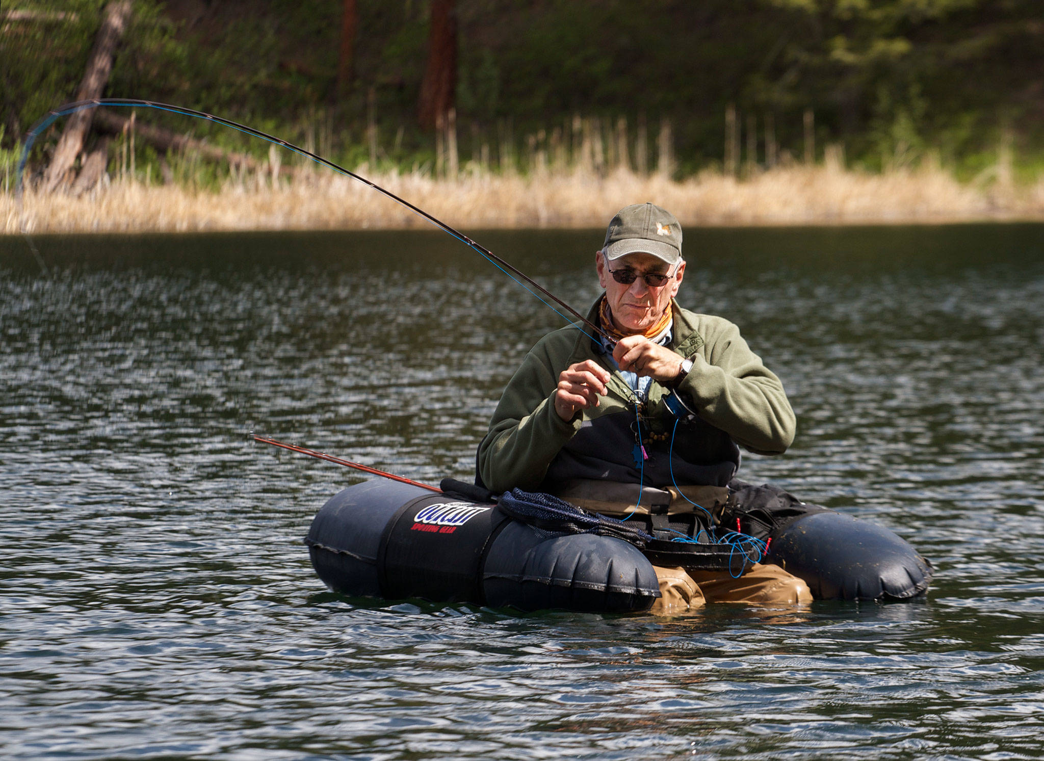 Chuck Morrison plays a trout that grabbed his fly at Black Pine Lake near Twisp. (Mike Benbow photo)