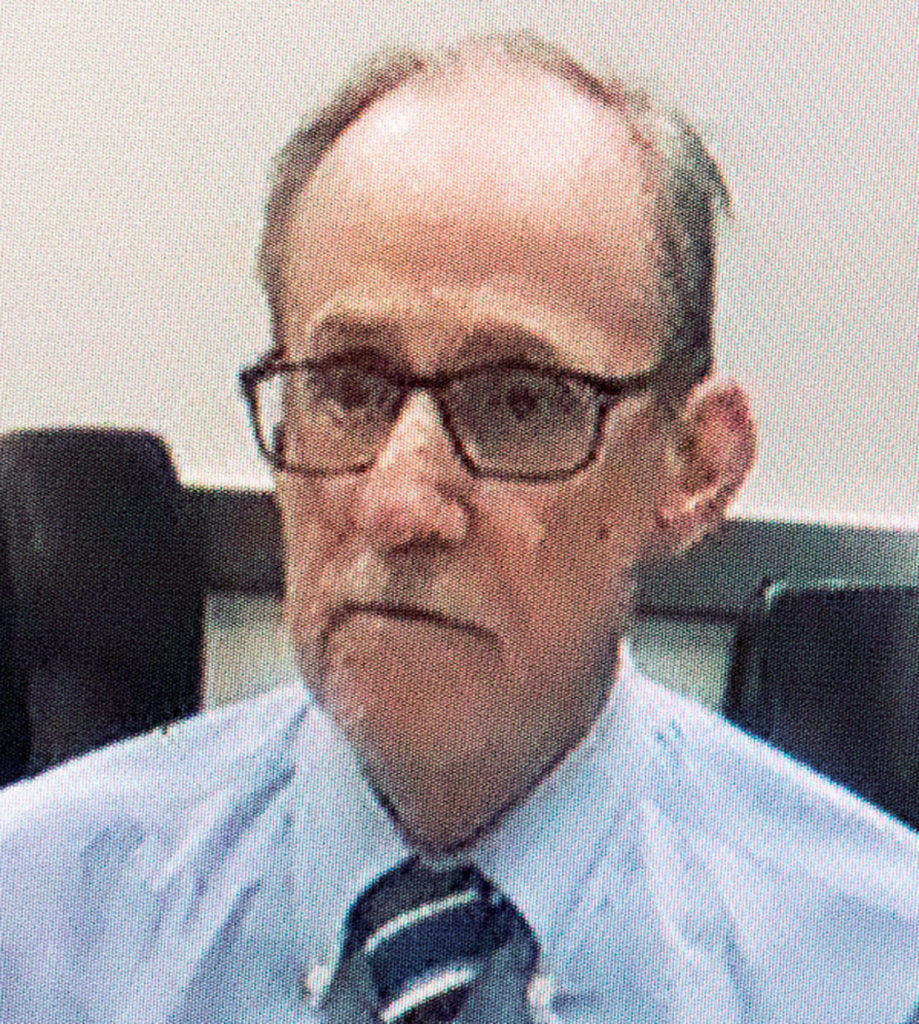 Via video monitor April 15, Terrence Miller, a retiree living in the Edmonds area, pleaded not guilty to the first-degree murder of Jody Loomis in 1972, during his arraignment at Snohomish County Courthouse in Everett. His bail was lowered and stricter release conditions were added Friday by Judge David Kurtz. (Andy Bronson / The Herald)
