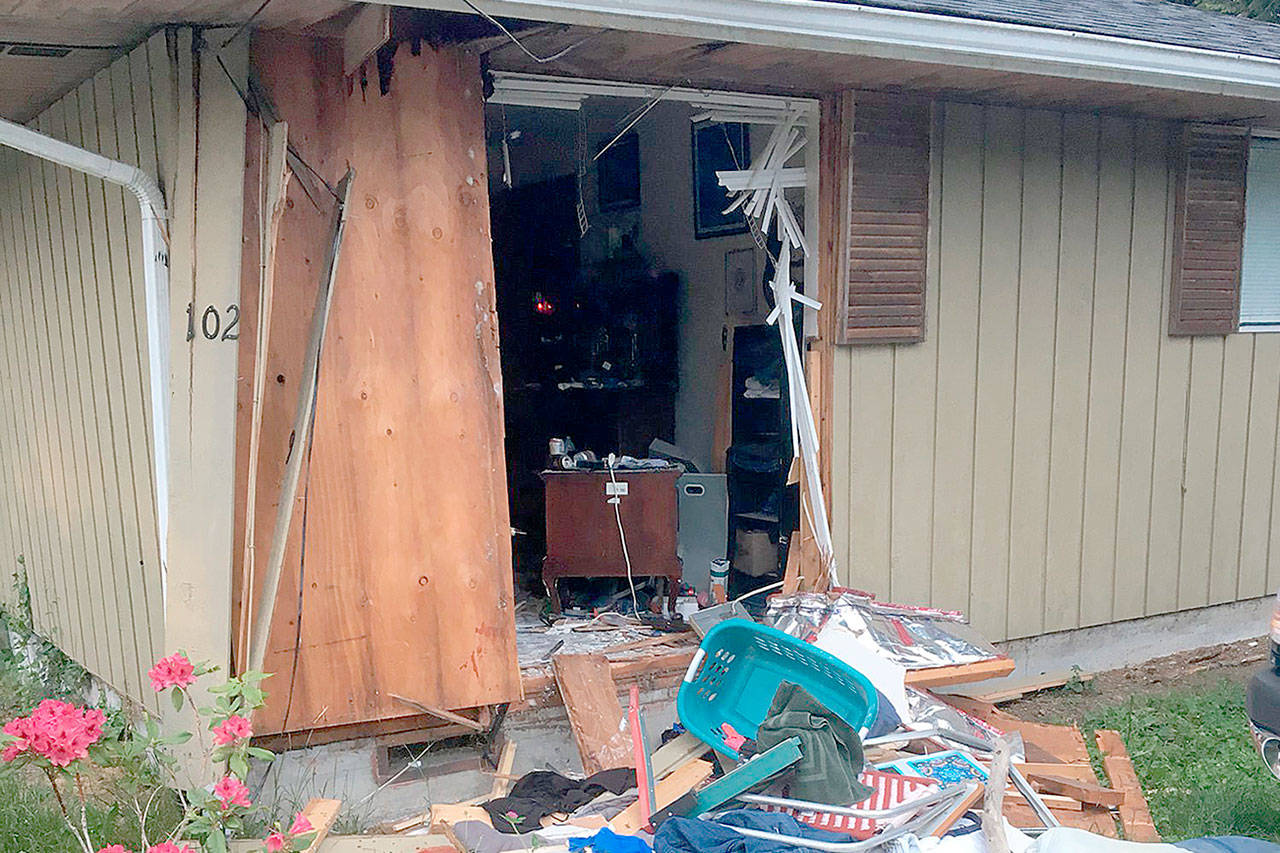A SWAT vehicle was used to break through a wall at a Snohomish home where an Everett man allegedly fired a 9mm handgun at a woman and refused to surrender Sunday evening. (Snohomish County Sheriff’s Office)