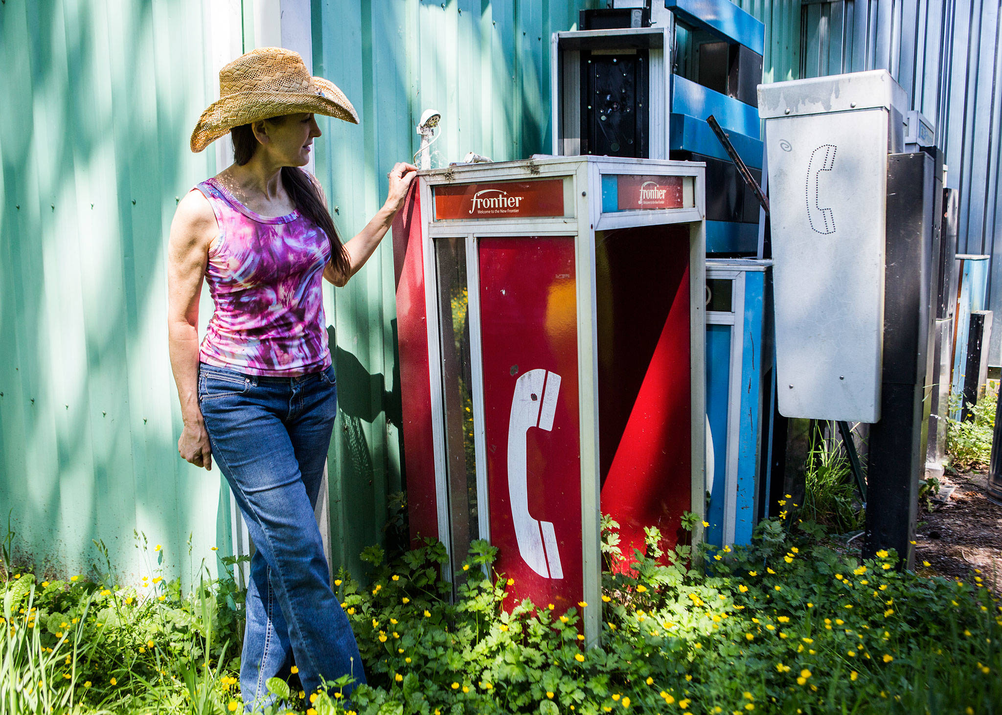 Cynthia Marie, owner of Highway 2 Collectibles & Imports in Sultan, started out with more than 100 retro pay phone booths that people have bought to use for things such as yard art, movie sets and outhouses. (Olivia Vanni / The Herald)