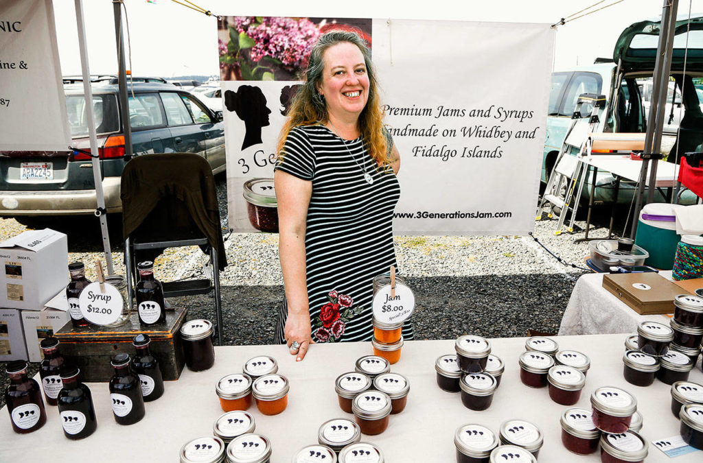 Rebecca Hood sells jams and syrups in the 3 Generations Jam booth at the Everett Public Market Sunday. (Dan Bates / The Herald)
